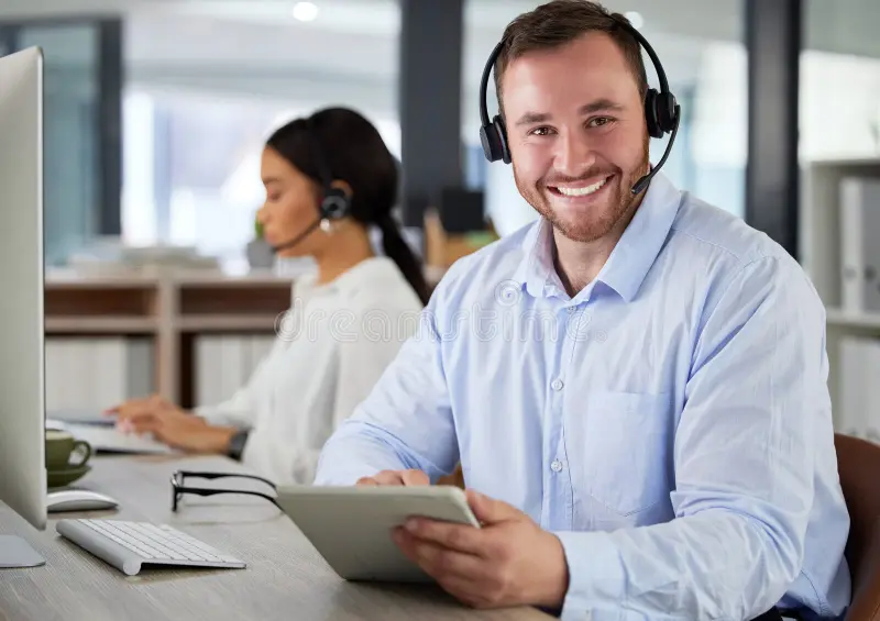 Friendly customer support agent with a headset and tablet